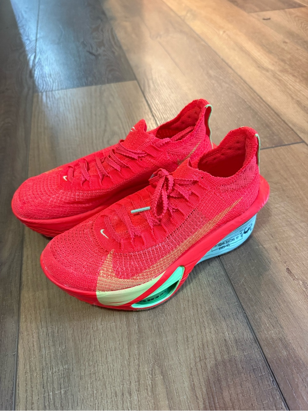 Nike Women's Alpha Fly Athletic Shoes in Bright Orange with Gold Accents